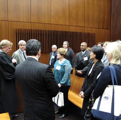 Image of group of men and women standing in courtroom