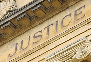 image of the word "Justice" on a federal court building
