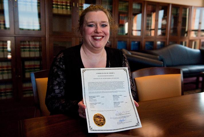 Miriam Vincent, a staff attorney for the National Archives and Records Administration, holds a certificate ascertaining South Dakota's 2012 electors.