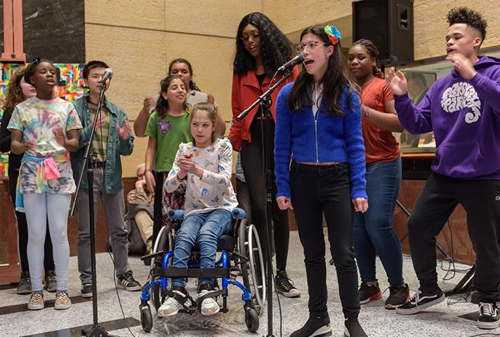 A song from the musical "The Girl Who Cried Different" is performed during a public reception at the Minneapolis courthouse. 