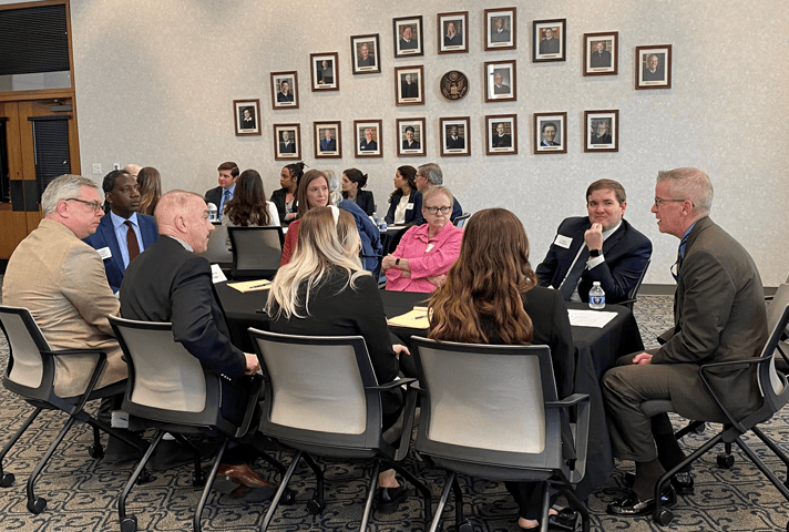 Attorneys and law students speak with federal judges during the Kansas City roundtable session.