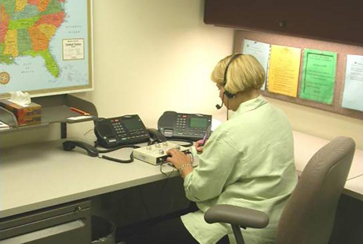 An interpreter provides language services remotely during a short court proceeding.