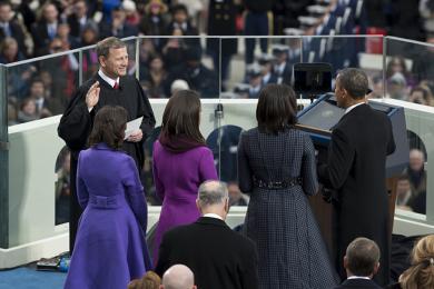 Chief Justice John G. Roberts Jr. administers the public oath of office to President Obama, as the president's wife and daughters watch.