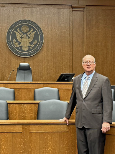 Judge Robert J. Conrad Jr. stands in a courtroom in Charlotte, NC.