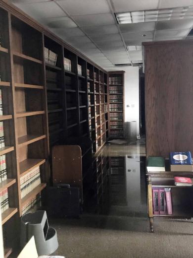 After walls and a section of roof were torn away, wind-driven rain caused severe water damage throughout the courthouse in Lake Charles, leaving standing water in the library.