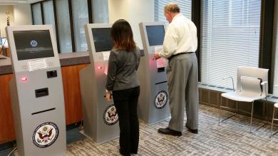 Jurirs demonstrate the check-in process on new jury kiosks 