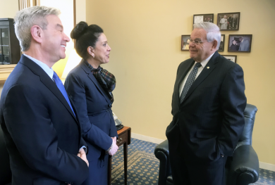 Judge Esther Salas speaks with Senator Bob Menendez, who cosponsored the legislation to protect judges. Salas’s husband, Mark Anderl (left), was wounded during a July 2020 attack at their home in New Jersey.