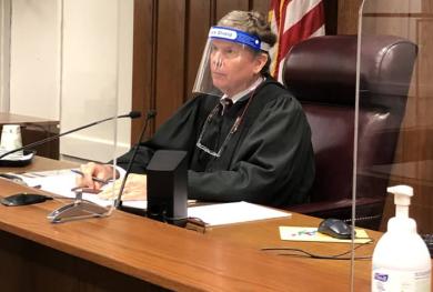 Judge James K. Bredar in plastic facemask 