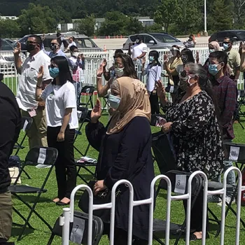 In St. Louis, new citizens take the Oath of Allegiance in a recently established drive-in theater. 