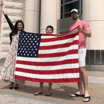 Andrea Christian, a newly naturalized citizen from Brazil, celebrates with her family outside the federal courthouse in St. Louis. 