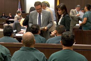 image of attorneys meeting with defendants before a hearing