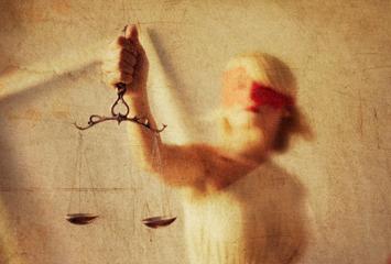 Lady justice holds the scales of justice in this visual representation.