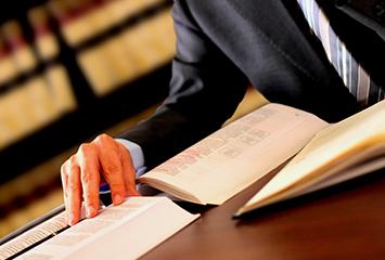 An image of a man researching various judicial resources for information.