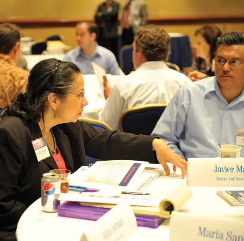 Image of woman and man sitting and talking at table