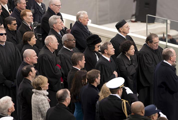 Members of the U.S. Supreme Court stand during ceremony.