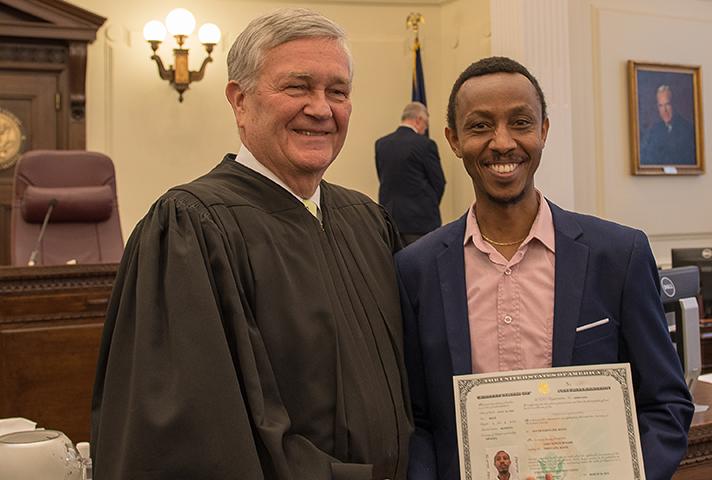 Senior Judge D. Brock Hornby shakes hands with a newly naturalized citizen. 