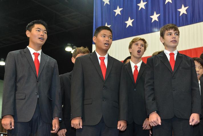 Students singing the National Anthem.