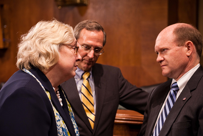 Sen. Chris Coons, right, confers with Judge Julia S. Gibbons and Judge John D. Bates, Director of the Administrative Office of the U.S. Courts.