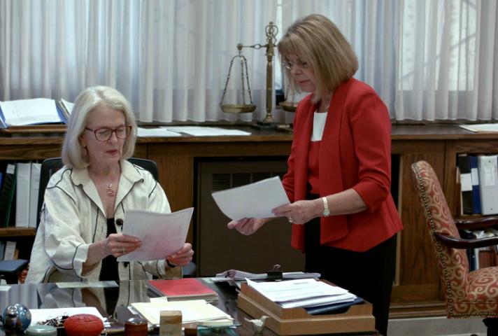 U.S. District Judge Janet Arterton, left, and Clerk of Court Robin Tabora look at documents. 