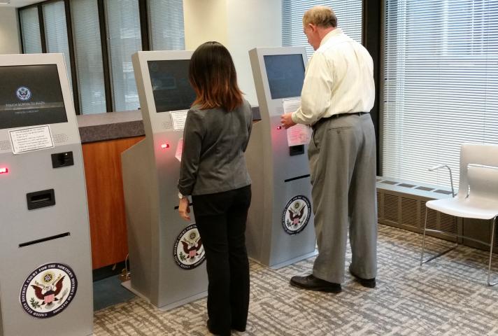 Jurirs demonstrate the check-in process on new jury kiosks 