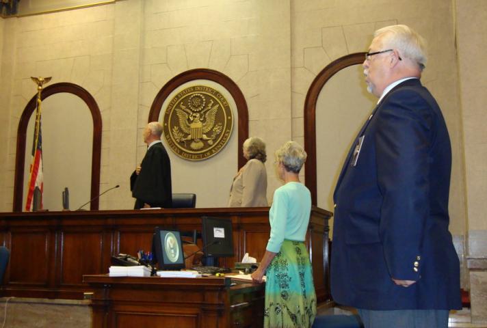 Federal judges conduct naturalization ceremonies -- usually in federal courthouses. 