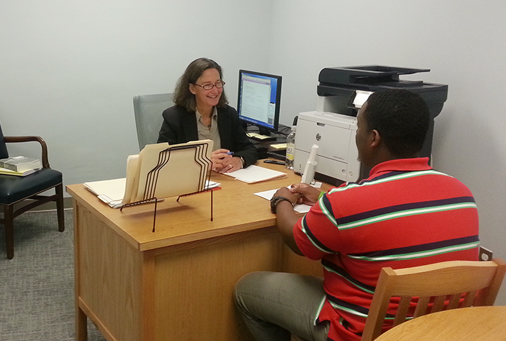 Center director Nancy Rosenbloom helps a pro se litigant in an office in the Eastern District of New York federal courthouse in Brooklyn.