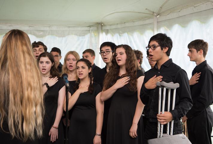 Students sing the National Anthem at a naturalization ceremony in Oyster Bay, NY.