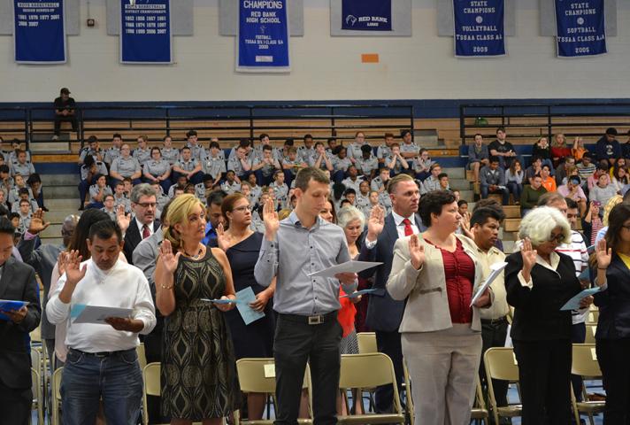 New citizens say the Pledge of Allegiance. 