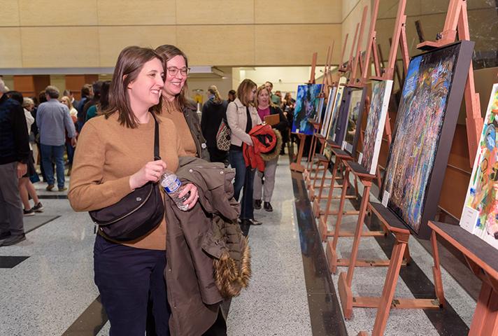 VIsitors admire pieces created by artists with developmental disabilities during a public reception at the federal courthouse in Minneapolis.