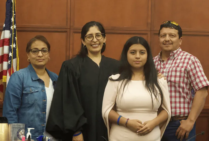 U.S. District Judge Diana Saldaña welcomes high school student Odete Coss and her parents at the Laredo, TX, federal courthouse.