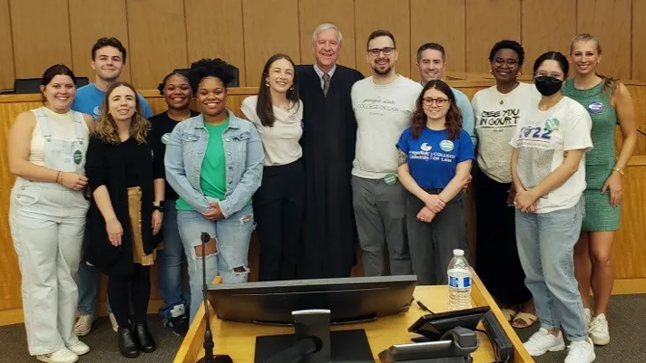 U.S. District Judge Richard Story is seen with Georgia State University law students following the mock trial component of the Street Law program.