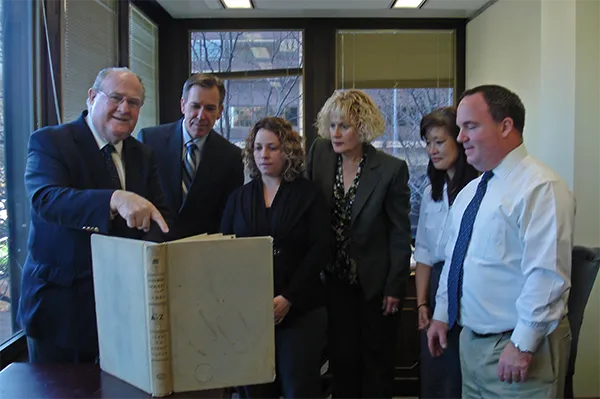 Michael Kunz, left, Clerk of the Eastern District of Pennsylvania, points to a book with handwritten docket entries that he worked with in the early 1960s. Kunz was among the federal courts' pioneers in adopting the online PACER information service. With Michael Kunz, left, Clerk of the Eastern District of Pennsylvania, points to a book with handwritten docket entries that he worked with in the early 1960s. Kunz was among the federal courts' pioneers in adopting the online PACER information service. With