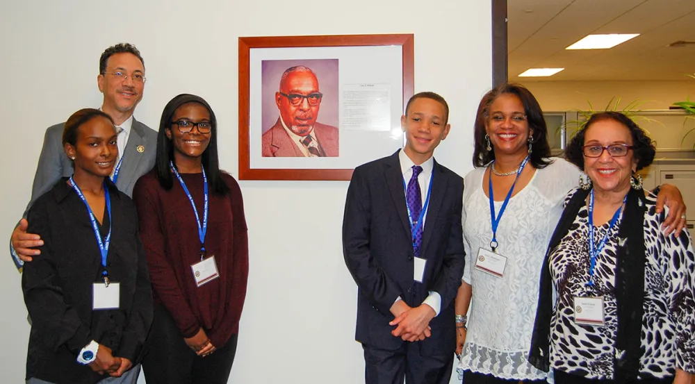 Leon E. DeKalb’s family members pose with a photo of him during a 2016 ceremony honoring probation officers in the Southern District of New York