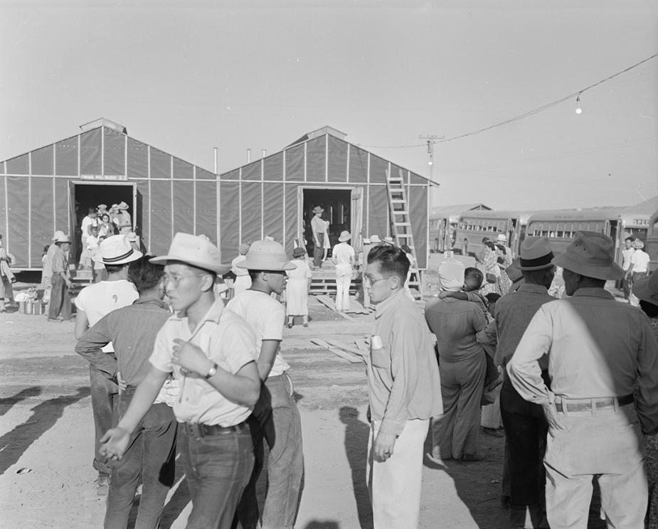 Newly arrived internees explore the Poston Center in Arizona in May 1942, while barracks were still under construction.