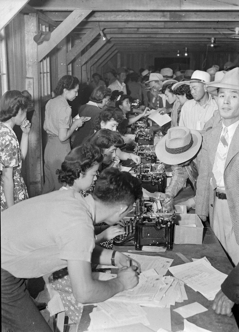 At Poston War Relocation Center, where future judge A. Wallace Tashima lived three years as a child, internees stand in registration line.