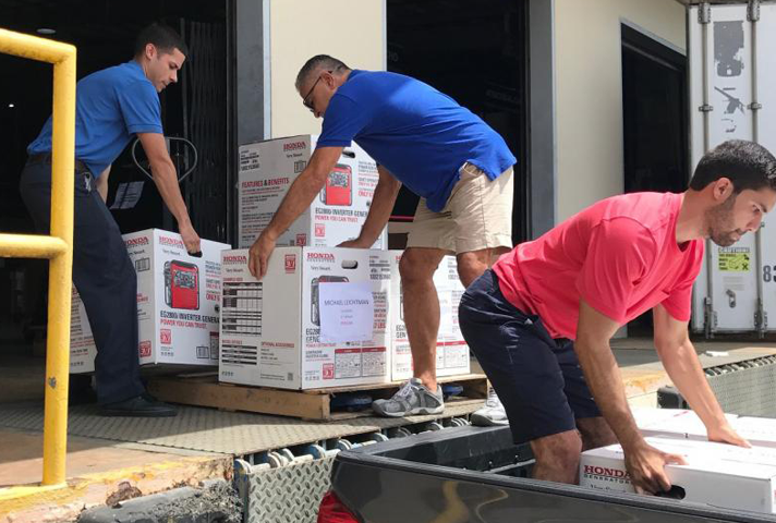 Federal defenders in Puerto Rico load generators onto a truck for transport to the Virgin Islands, which was hit by two hurricanes in a matter of weeks in 2017