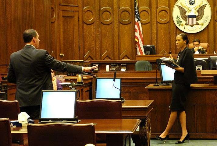 Chanise Anderson, a lawyer attending the Litigation Academy, receives feedback about entering documents into evidence during a training session in a Providence, RI.
