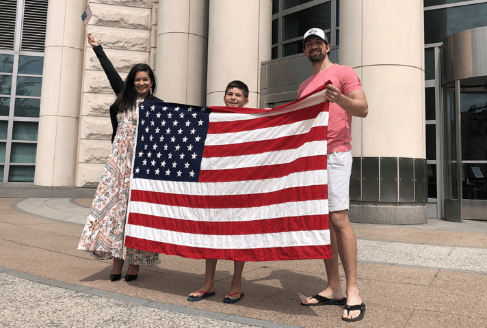 Andrea Christian, a newly naturalized citizen from Brazil, celebrates with her family outside the federal courthouse in St. Louis. 