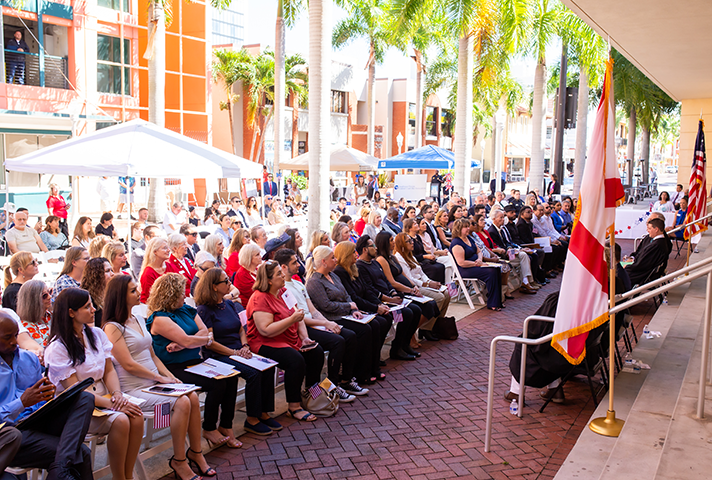 New citizens gather for a naturalization ceremony outside the courthouse in Fort Myers.