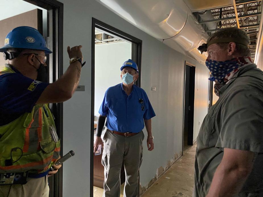 S. Maurice “Maury” Hicks (center, in blue shirt), chief Judge of the Western District of Louisiana, inspects the damaged Lake Charles courthouse. 