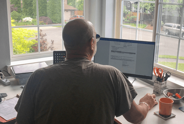 Image: Probation officer works at his computer from home.