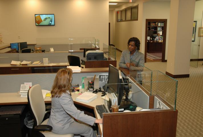 Two women speaking in an open central office space