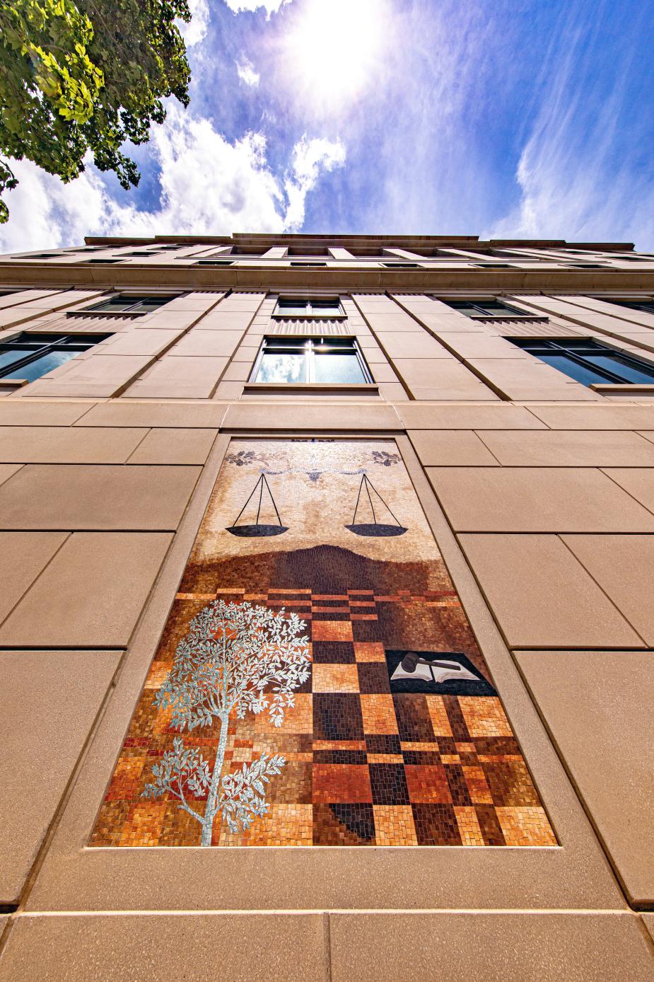 One of seven mosaics by artist Ellen Driscoll features the scales of justice on the outside walls of the new annex.