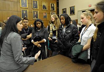 Attorney with students in courtroom